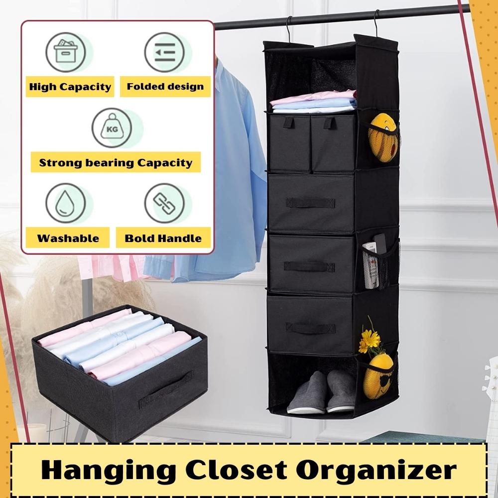 A hanging closet organiser with folded clothes on its shelves